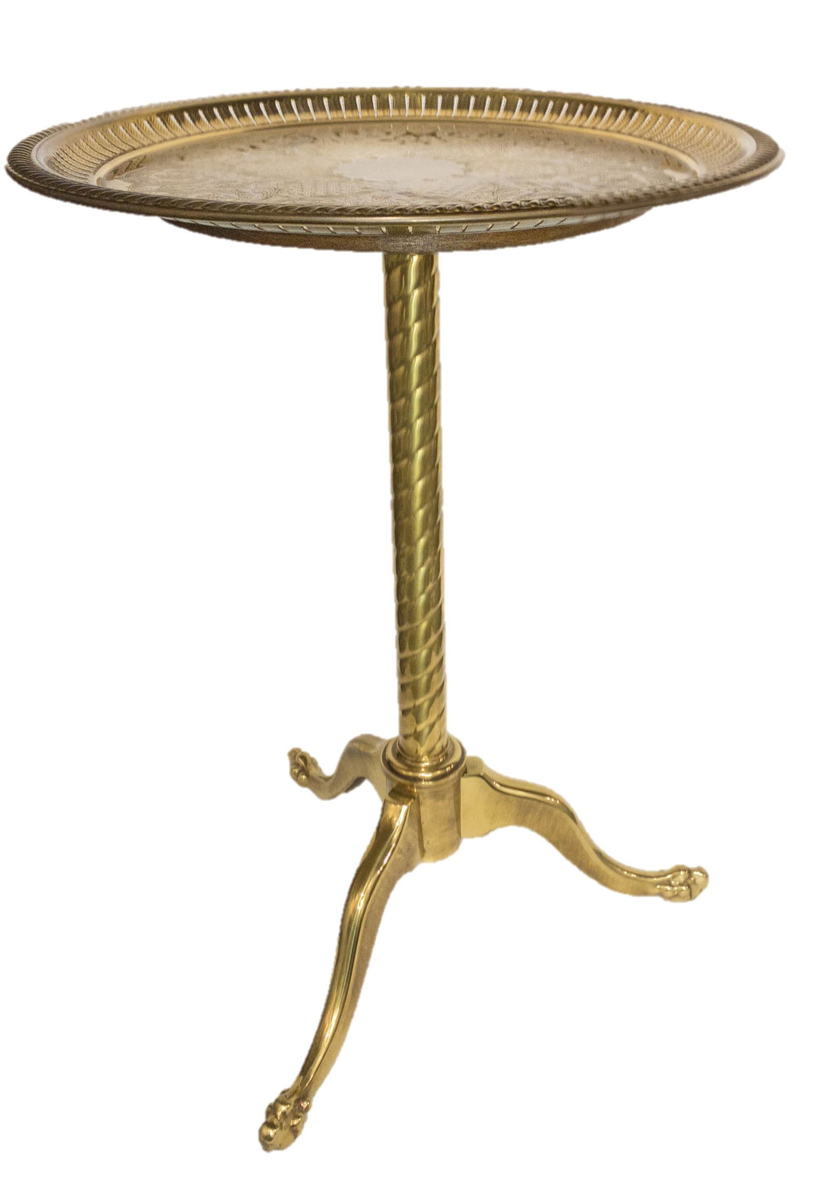 Vintage Brass Round Tray Table: Vintage brass tray table featuring a round top with highly detailed ornate etching and engraving on a twisted single leg 3 footed base. 21" high, 15.5" diameter top.