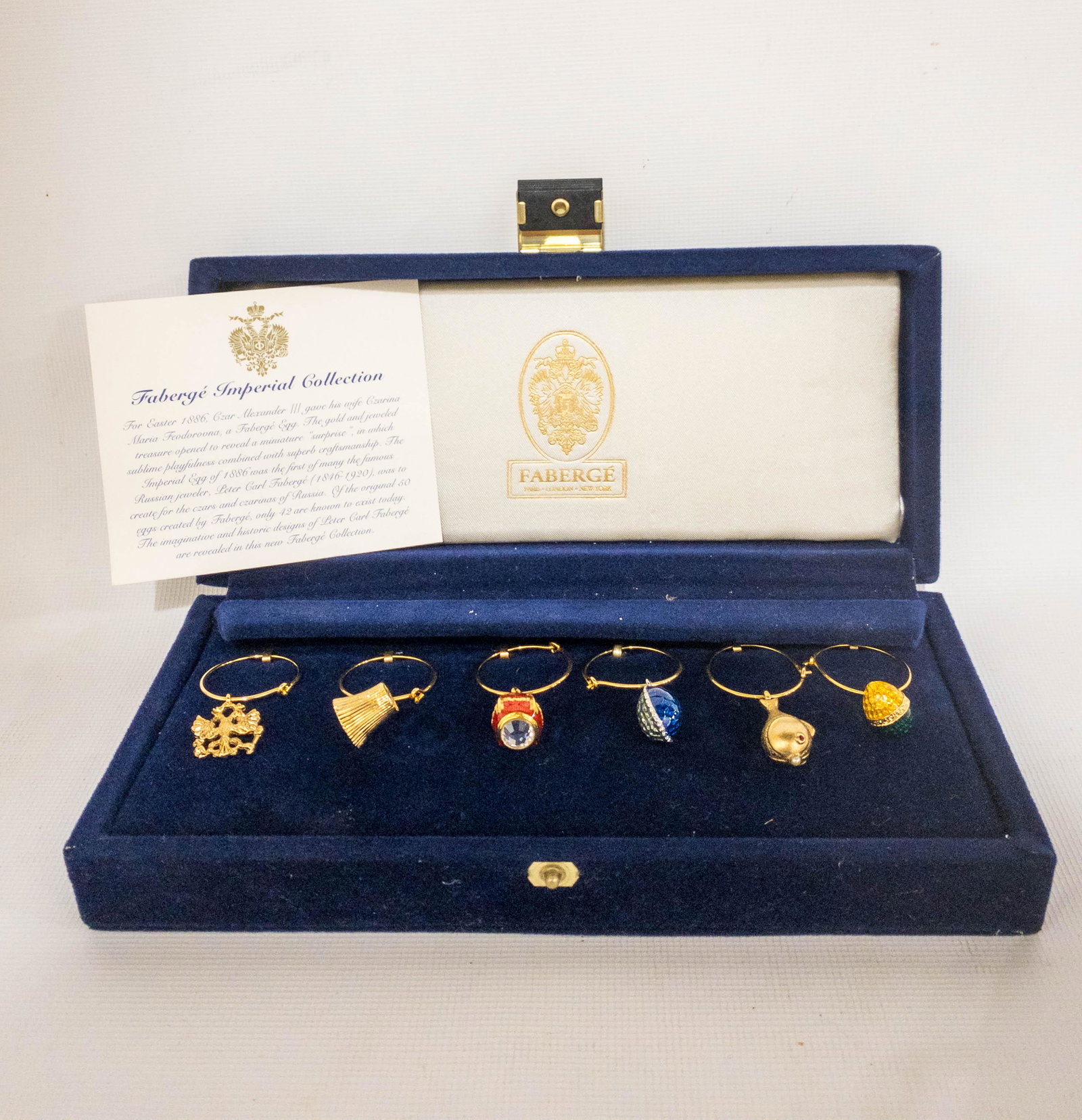 Faberge Imperial collection Wine Glass Marker Charms: A set of 6 Faberge Imperial Collection wine glass charms in presentation box. Charms: approximately .75" each.