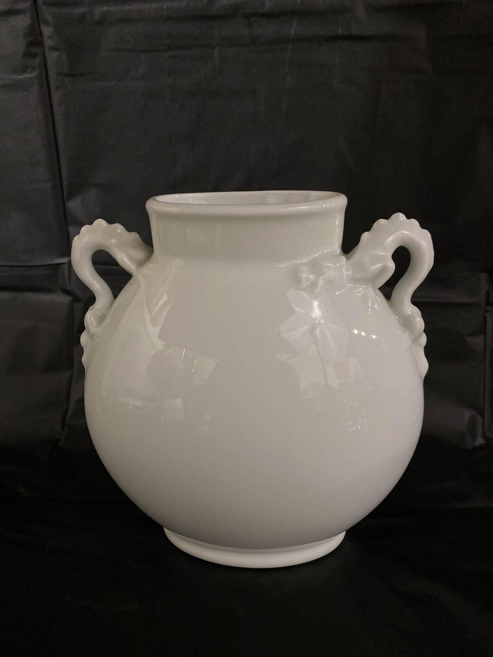 Giraud Limoges France White Porcelain Dragon Urn Vase: Giraud Limoges vase in stark white porcelain with sculptural dragon handles. Marked on bottom: Giraud, Limoges, France. 8.25" high x 8" long x 4" wide.