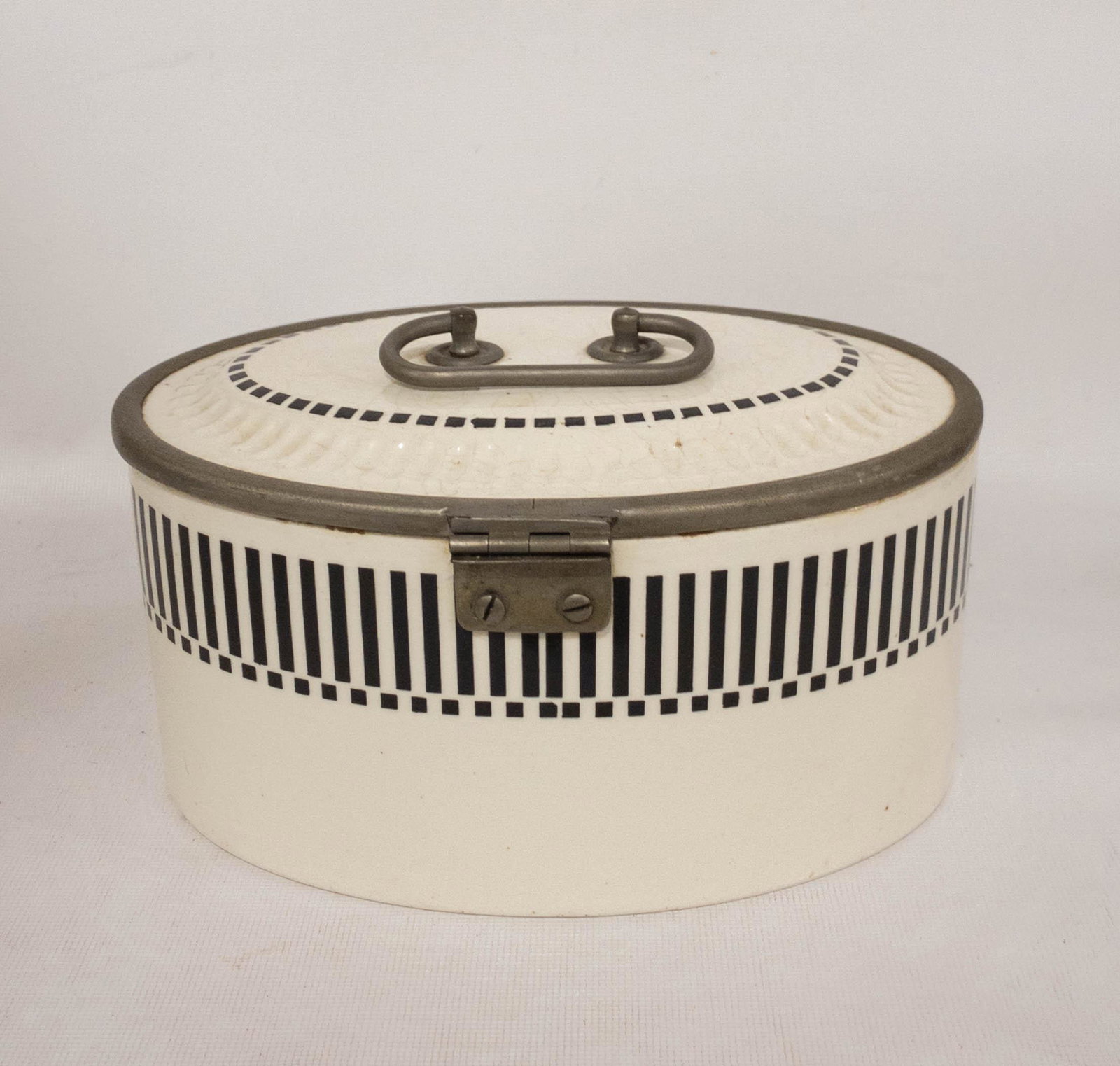 Antique German White & Black Biscuit Jar: Antique German biscuit jar in white porcelain with a black geometric design and metal lid frame, latch and handle. 4" high x 8.5" long x 5.5" wide.