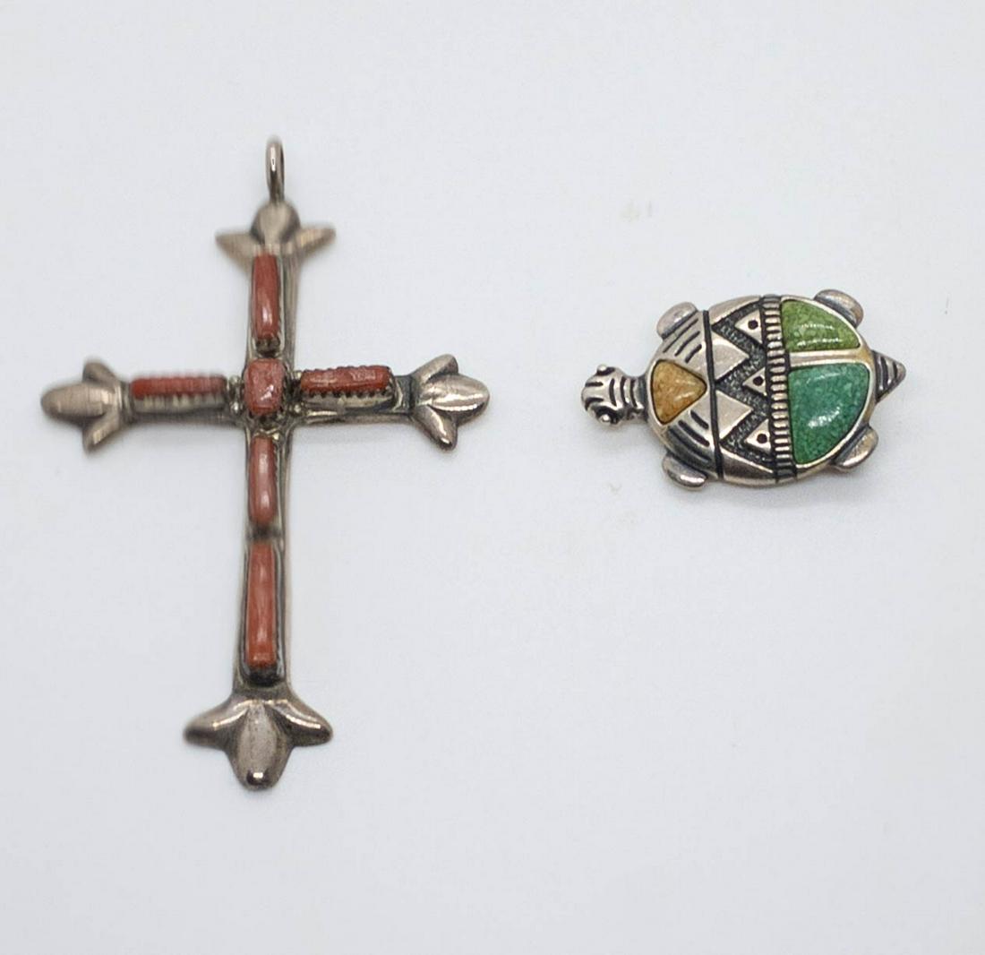 Zuni Leekity Coral Cross Pendant and Inlaid Stone: 2 sterling silver Zuni pendants including a cross with red coral set in saw tooth bezels, signed G&L Leekity, 3" long x 2" wide, and a turtle pendant or brooch with inlaid green and brown stones, mark