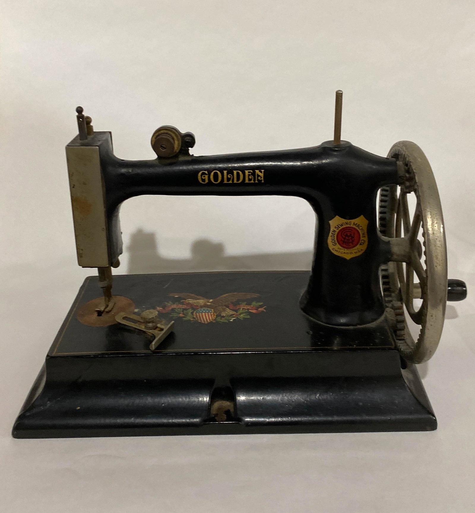 Antique Golden Sewing Machine Hand Turn Wheel: Antique sewing machine by the Golden Sewing Machine Company with a hand turnwheel. 8" high x 10" long x 5" wide.