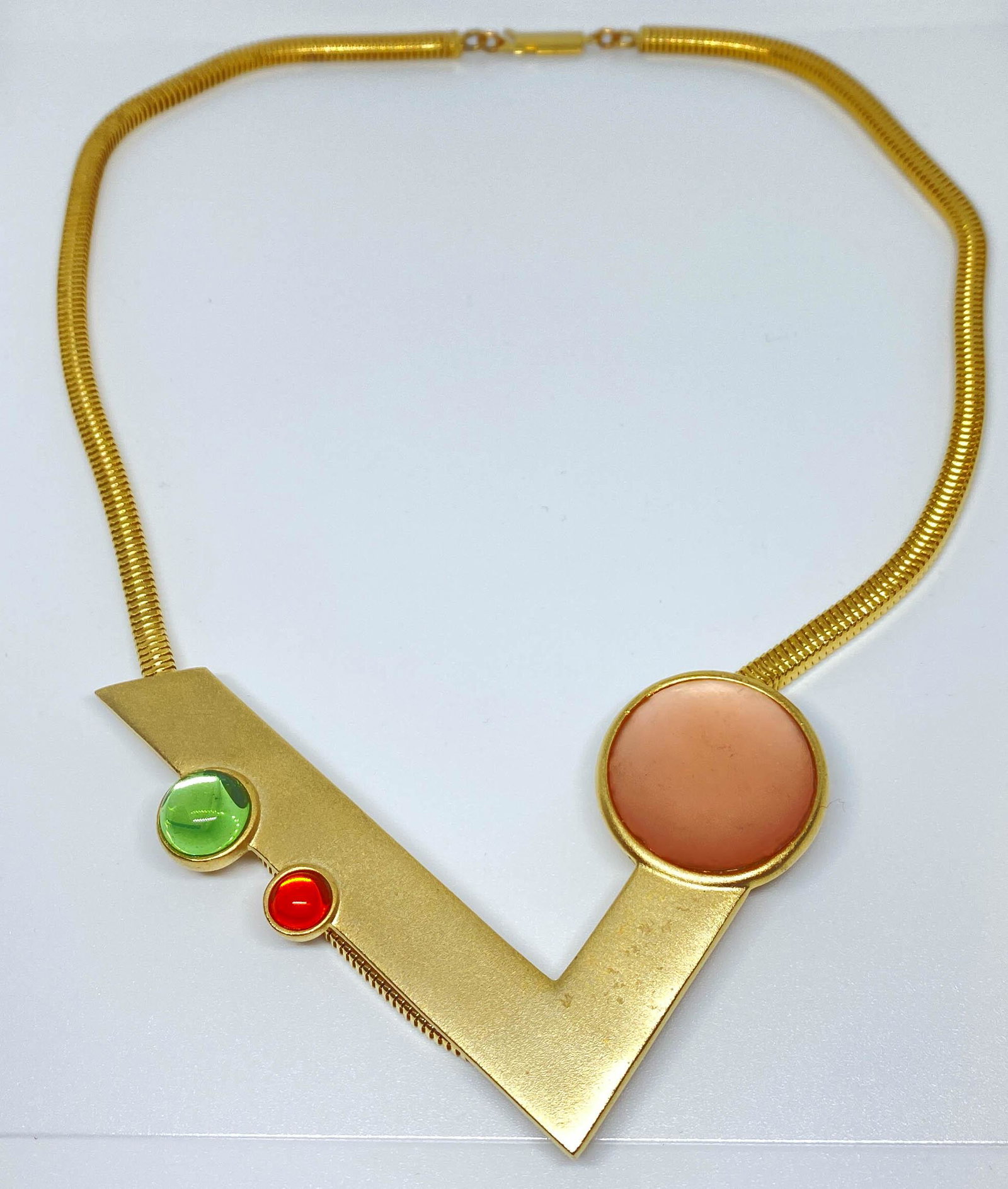 Ben Amun Necklace Gold tone 1980's Signed: Signed Ben Amun necklace featuring a geometric designed angle with crystal cabochons hanging on a 4.3mm square snake chain. Stamped: Ben Amun. 18" long.