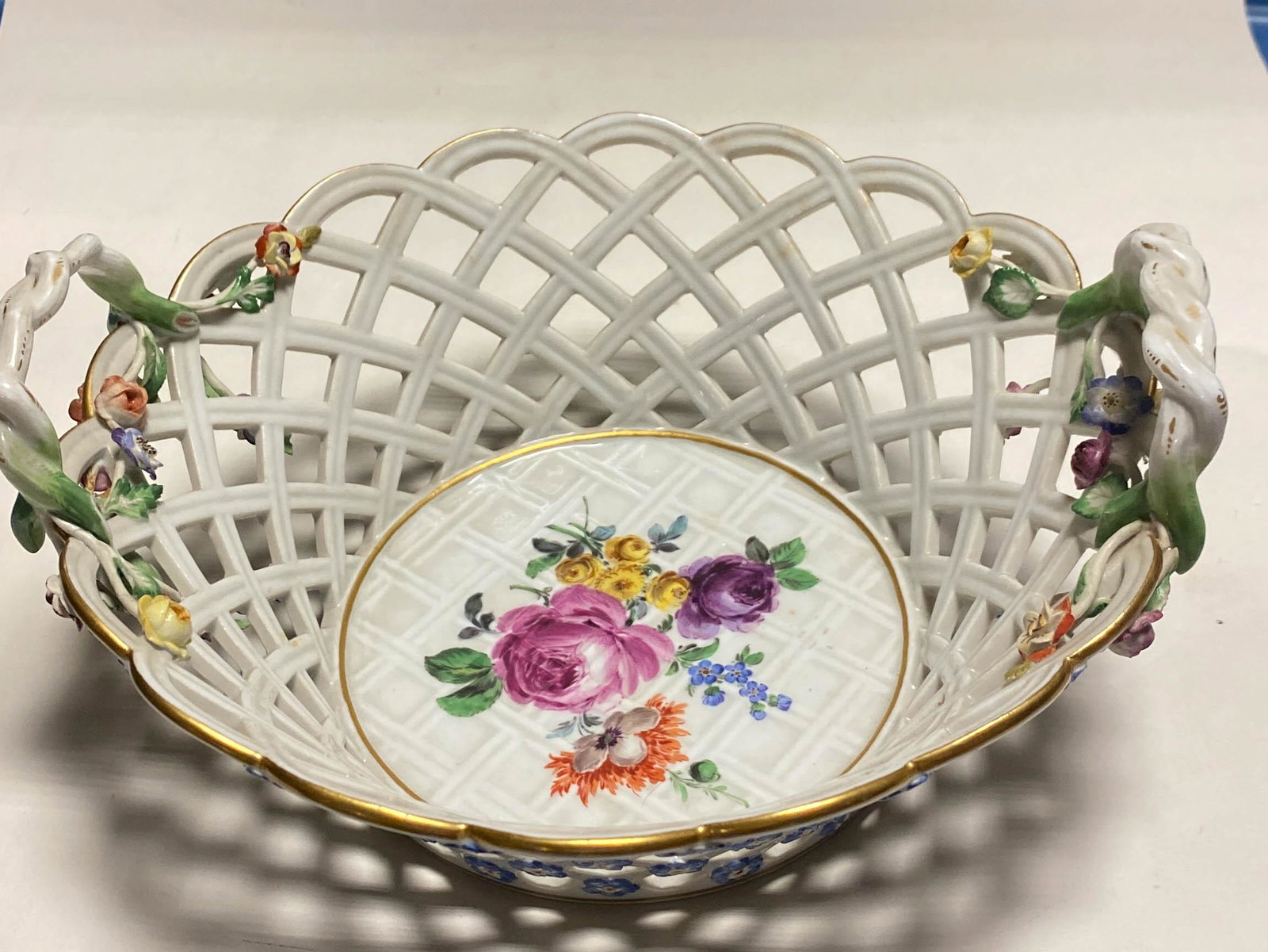 Antique Meissen Porcelain Floral Woven Basket Bowl: Antique Meissen porcelain basket bowl with open sides in a woven pattern, double handles, and accented with 3 dimensional flowers.10" diameter, 3.5" high