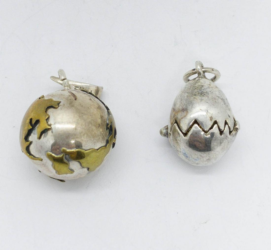 2 Sterling Silver Necklace Pendants Globe & Egg: 2 Sterling silver pendants: a globe pendant with gold washed continents, 30mm diameter, and a unique egg pendant that opens to a gold washed bird perched inside, 30mm long, 24mm diameter. Total weight