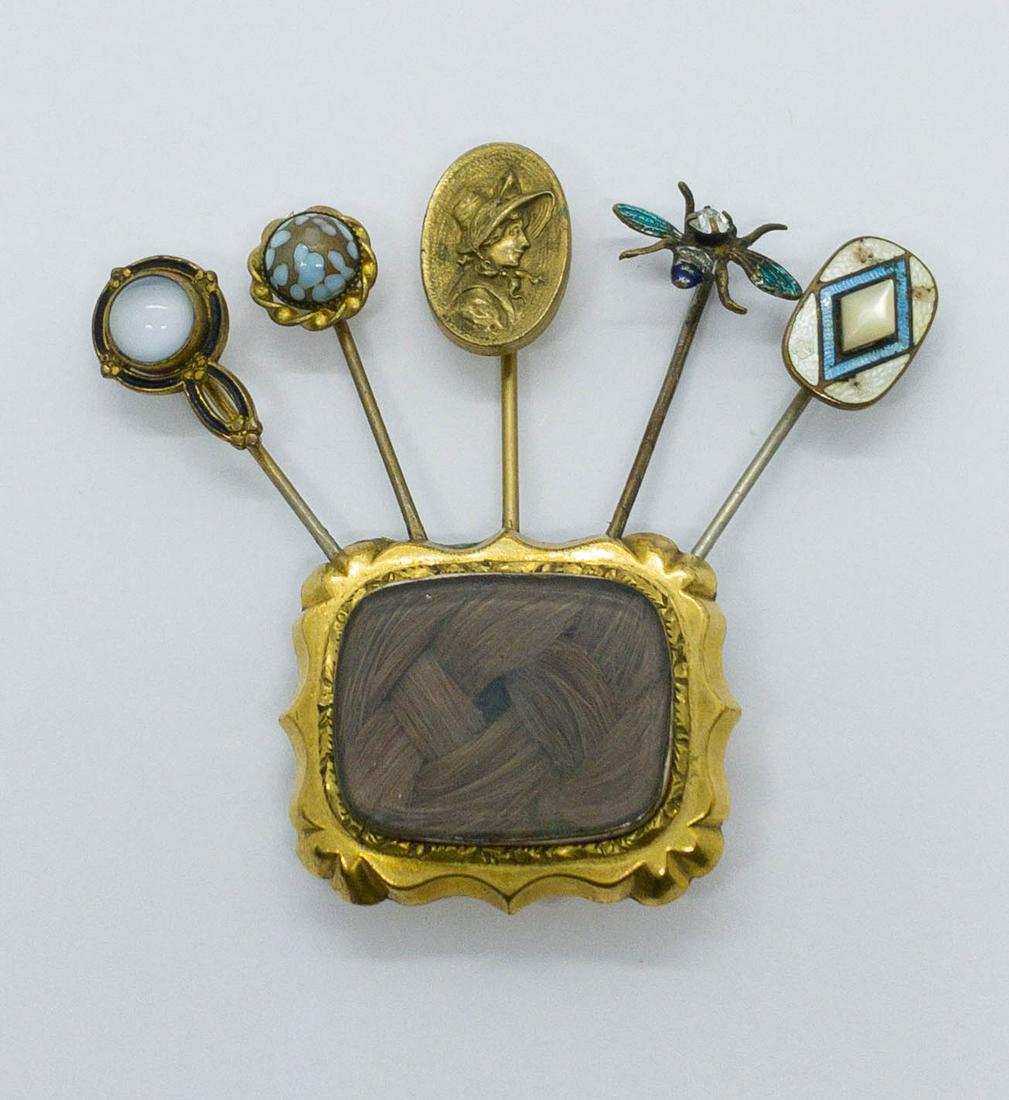 Handmade Victorian Pinchbeck Memorial Brooch: A unique Antique pinchbeck memorial brooch featuring a square pin with woven hair under glass and 5 attached pins boasting enamel, crystal, and moonstone.