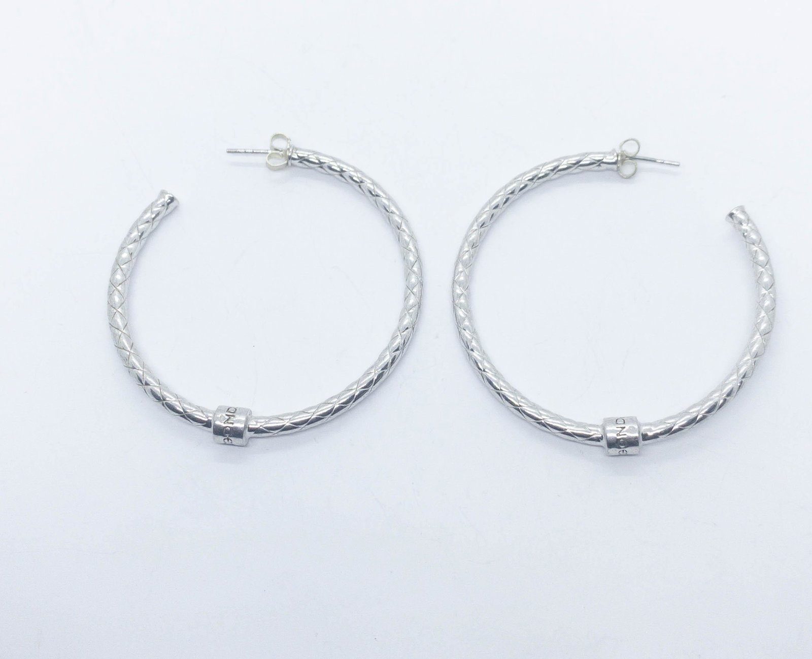 Pianegonda Sterling Silver Quilted Pierced Hoop: Large sterling silver hoops with a quilted design from Pianegonda. Posts. 2" diameter. Weight: 11.8 grams.