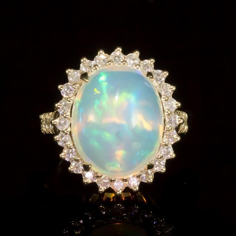 14K Gold 7.02ct Opal 1.11ct Diamond Ring: Retail: $10,190.00****** 14K Gold Opal & Diamond Ring ****** Metal: 14K Solid Yellow Gold / Total Item Weight: 7.6 grams / Country Made: United States / / Main Stone: Opal / Color: Play of Color / Car