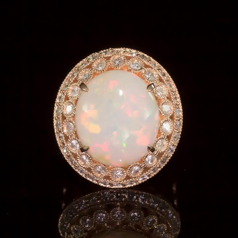 14K Gold 6.59ct Opal 1.55ct Diamond Ring: Retail: $11,920.00 ******14K Gold Opal & Diamond Ring ****** Metal: 14K Solid Rose Gold / Total Item Weight: 11.0 grams / Country Made: United States / / Main Stone: Opal / Color: Play of Color / Cara