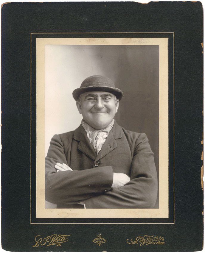 Antique Photo Gurning Man Wearing Bowler Hat: This is an antique photo of a man gurning and wearing a bowler/derby hat. Attached to a Carbonette paperboard mount. 105 Fourth Ave., New York. SIZE: Approx. 8" x 10" including mount. ----------------