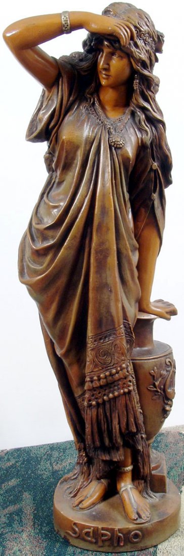 Beautiful Antique c1890 33" Sapho/Sappho Plaster Statue: This is an antique statue of a beautifully detailed woman leaning on a large amphora decorated with a lyre. A lot of attention given to her long hair, jewelry, and clothing. Bronze glaze over plaste