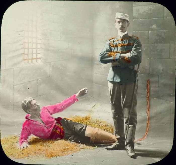 c1900 Lantern Slide CUBAN CAPTIVE Prison/Death Jailor: This is an antique glass lantern slide. Circa 1900. Hand colored. Titled The Cuban Captive. This slide has a sticker in the corner like the one on the slide titled Sailor on Maine that we have in this