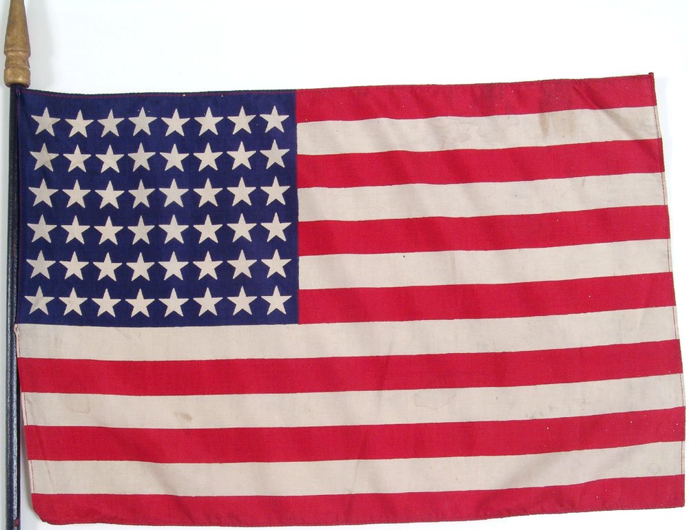 Old 48 Star American Parade Flag - Silk on Wood Staff: This is a fantastic vintage 48-star silk American parade flag. On a black wood staff with a gold wood finial. SIZE: 17" x 11 1/2". 33" staff. ****** We provide in-house shipping. Low shipping costs! C