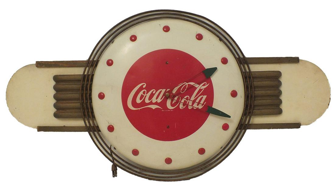 Coca Cola Clock: Round electric clock with the iconic Coca Cola Script across the face and dots serving as numbers with wings on each side. Reg. U.S,A, Pat. Off. Diameter of clock is approx. 16". Add the 8.5" wings fo