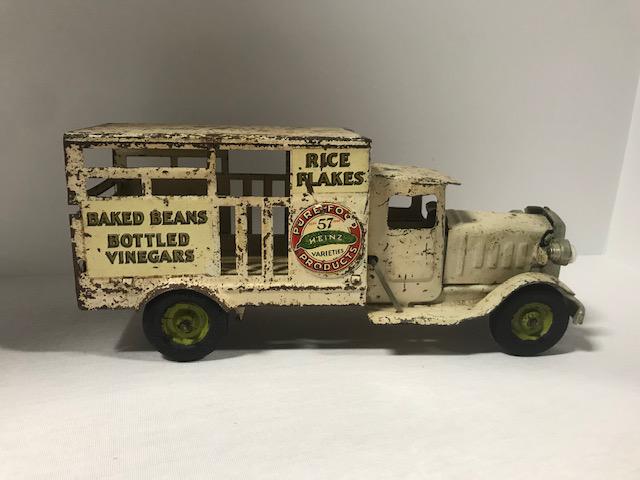 Delivery Truck: Well worn metal delivery truck advertizing Heinz products, Baked Beans, Bottled Vinegar, and Rice Flakes.