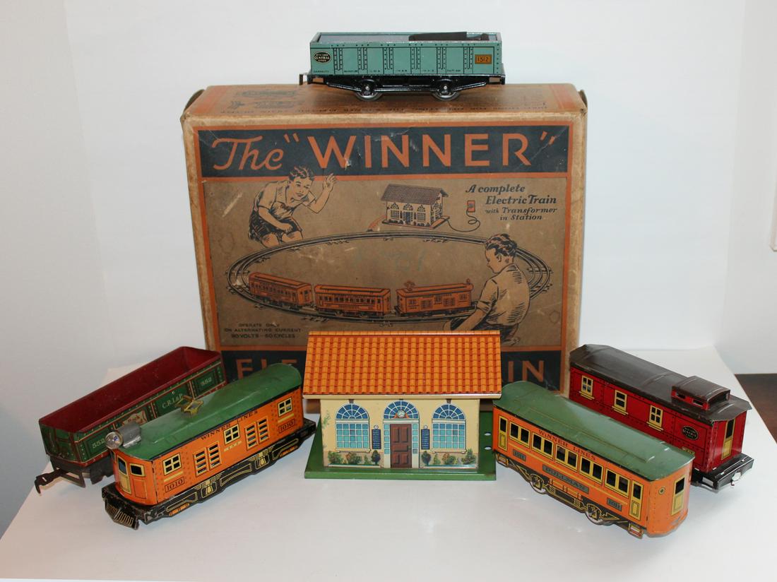 Winner Train Set: "The Winner" Electric Train Set in original box with station, transformer and track. Includes additional pieces to those pictured on box. See accompanying photo is absent one car that is actually incl