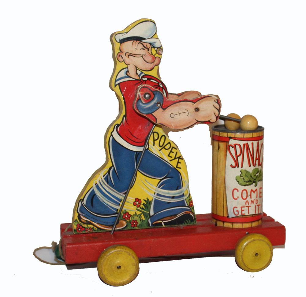 Popeye Pull Toy: Popeye drumming on spinach can pull toy. Nice paper graphics applied to wood figure. Some wear on wheels.