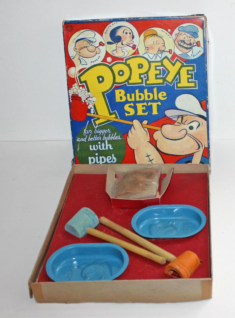 Popeye Bubble Set: Popeye Bubble Set in original box. Transogram Co., New York. Two pipes and dishes, one complete Popeye Soap. Box is worn and separating at the seams in a few places. Â© 1919, 1929, 1933, KFS. Box me