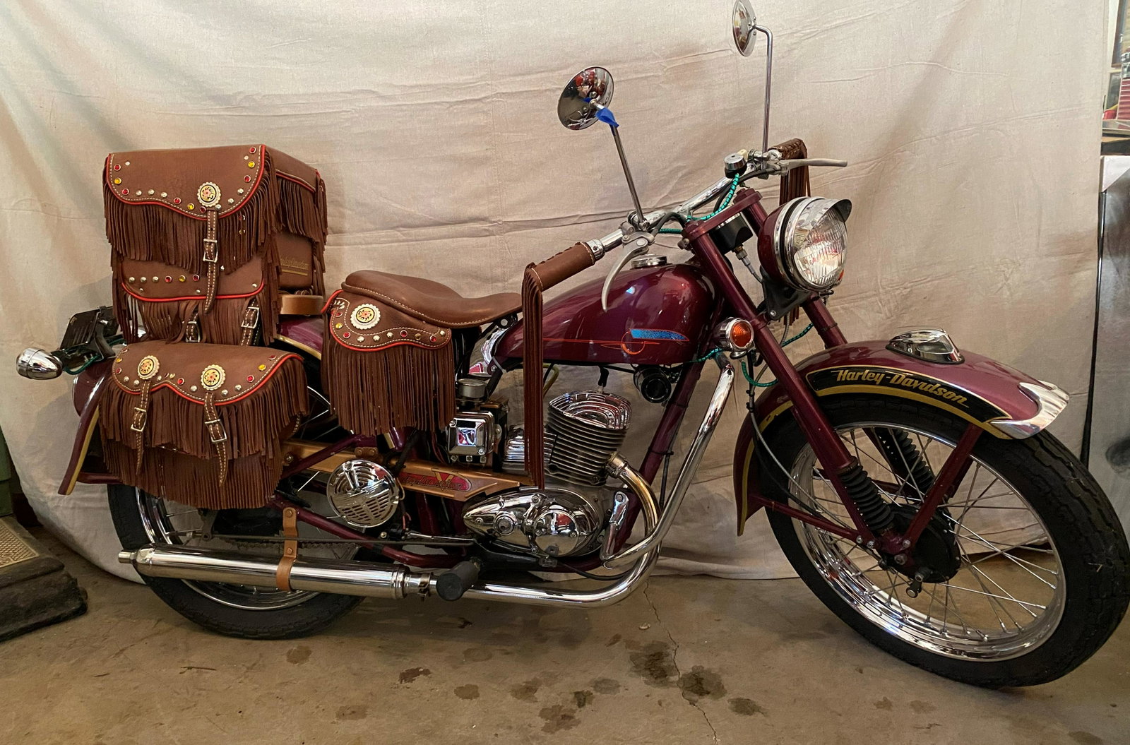 1958 Harley Davidson Teleglide Show Bike. Totally: 1958 Harley Davidson Teleglide Show Bike. Totally restored exhibition bike: Custom burgundy show paint with lots of chrome, full array of fringed leather, jeweled with medallions, saddle, saddle lugga