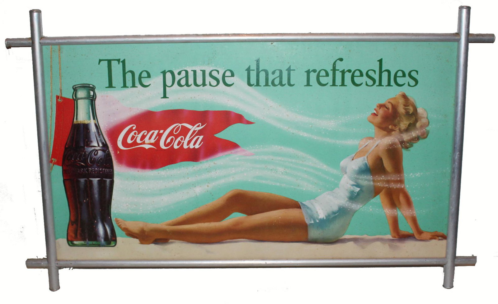 Cardboard Coca Cola sign in aluminum frame depicting a: Cardboard Coca Cola sign in aluminum frame depicting a young woman in swimsuit - The Pause that Refreshes. No printer's info located. Perhaps is under frame. Some soiling due to age and exposure to en