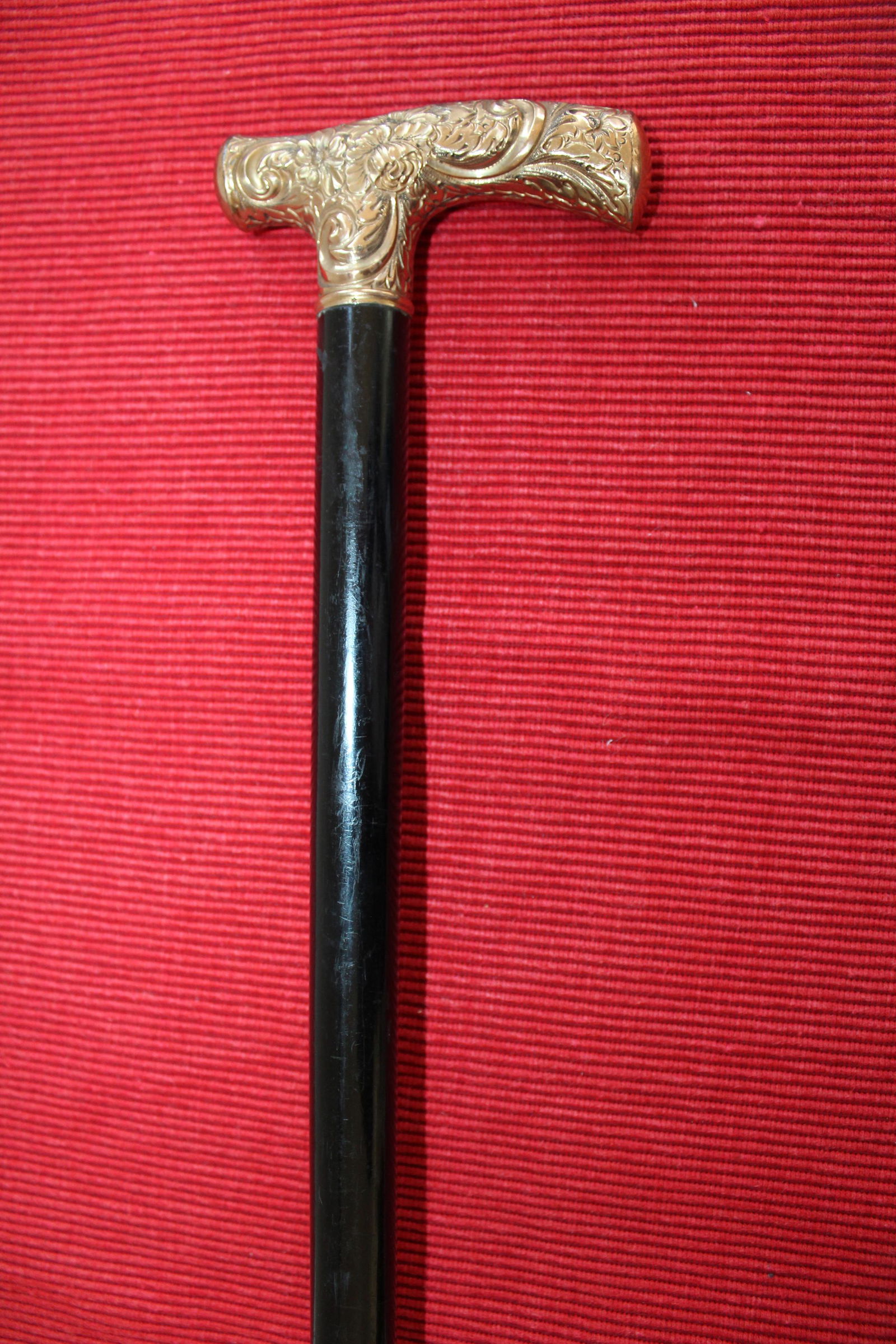 Black ebonized walking cane with gold handle marked. (1 of 1)