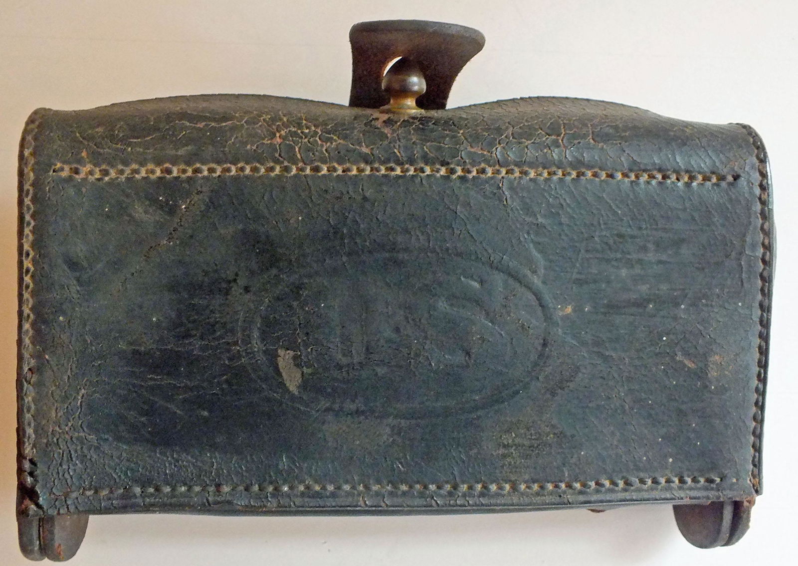 Civil War era leather cartridge pouch with US embossed: Civil War era leather cartridge pouch with US embossed on front. Top flap closure with no. 20. Leather loops on back for attaching to belt. Worn, but nice. Approx. 4 x 6.