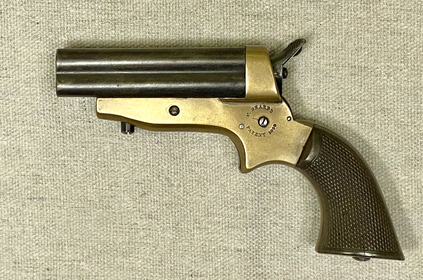Sharps 4-shot, 4 barrel pepperbox revolver. #16702.: Sharps 4-shot, 4 barrel pepperbox revolver. #16702. brass frame. .32 caliber. Ca. 1859. Gutta-Percha checkered grips.