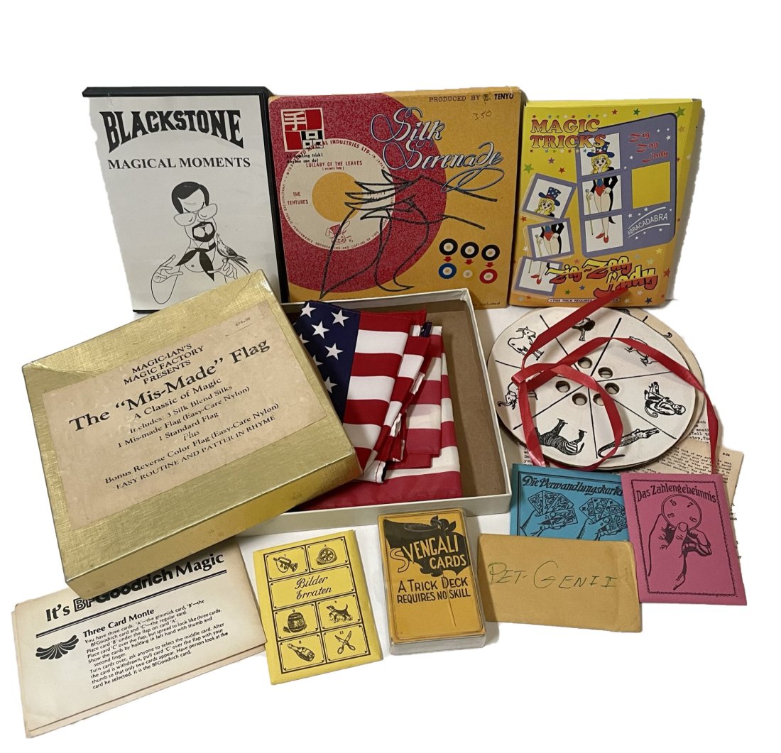 Group lot of magic cards/tricks: Chu's magic zig zag lady, Tenyo silk serenade, Blackstone magical moments DVD, The Animal Hunter with directions, Magic-Ian's magic factory The Mis-Made Flag with bonus revers color flag with directio