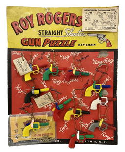 DISPLAY BOARD OF ROY ROGERS PLASTIC GUN PUZZLES: DISPLAY BOARD OF ROY ROGERS PLASTIC GUN PUZZLES MEASURES 10.5 X 14 X1 INCHES