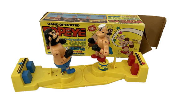 ORIGINAL HAND OPERATED POPEYE VS BRUTUS BOXING GAME. PLASTIC: VINTAGE ORIGINAL 1981 HARMONY HAND OPERATED POPEYE VS BRUTUS KNOCKDOWN-KNOCKOUT BOXING GAME. PLASTIC BODY CONSTRUCTION. MEASURES APPROX. 14 LONG X 3 ½ WIDE X 8 INCHES TALL WITH BOX