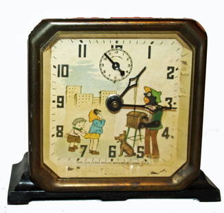 LUX CLOCK: PAINTED METAL CASE CLOCK W/BRASS TRIM. PAPER CLOCK FACE HAS THE LUX CLOCK MFG. CO., WATERBURY, CONN., U.S.A. AND SHOWS FULL BODY IMAGE OF ORGAN GRINDER AND MONKEY, ORGAN GRINDER'S ARM IS SEPARATE,