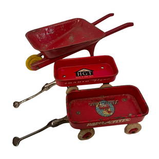 GROUP OF 3 (2) MINATURE WAGONS AND WHEEL BARREL: GROUP OF 3 2 WAGONS AND WHELL BARREL INCLUDING 2 SMALL RED RADIO FLYER WAGONS APPROX 3INCHES EACH ONE WITH HGT MARKED ON THE INSIDE AND THE OTHER MARKED RADIO LINE AND A RED WHEEL BARREL