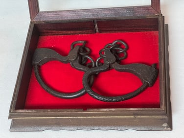 LEG IRONS IN GLASS CASE