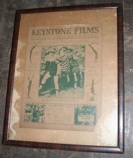 Keystone Film Adv.: Framed Keystone Film adv. Dated 1913. Featuring Chalie Chaplin and other stars. Faded graphics depict women in vntage swimware. Damage at top center. Bottom Right corner absent. Poster 10.5 x 14.25. S