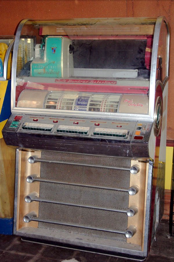 Seeburg Model V Jukebox: Jukebox is missing coin door. Good mech cover. End caps all right. 200 selection. Chrome somewhat pitted. Good restorable box.