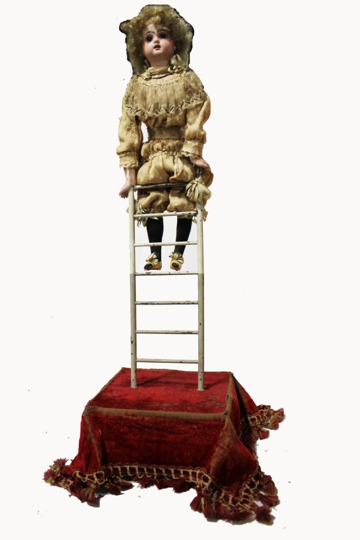 Clown on Ladder Automaton: Young figure balances on a stationary ladder atop a velvet covered wooden box platform. Costume appears to be original and appropriate to the period. Bisque head with glass paperweight eyes, closed mo
