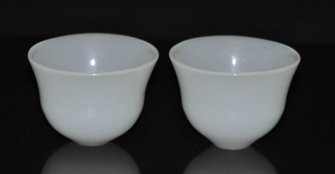 A pair of jade cups: A pair of jade cups. Height 4.5 cm. rom diameter 6.1 cm.