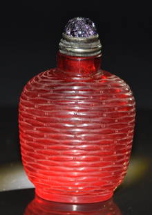 A fine 18th century carved ruby-red glass snuff bottle: A fine 18th century carved ruby-red glass snuff bottle. with stopper. Height 8.0cm. Provenance: Singapore private collection Mr Chen Hui Seng a retired entrepreneur and industrialist, is also an avid