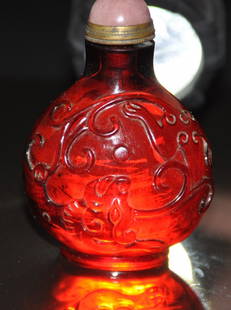 A fine Qing Dynasty carved ruby-red glass snuff bottle: A fine Qing Dynasty carved ruby-red glass snuff bottle. with pink tourmaline stopper. Height 8 cm. Provenance: Singapore private collection Mr Chen Hui Seng a retired entrepreneur and industrialist, i