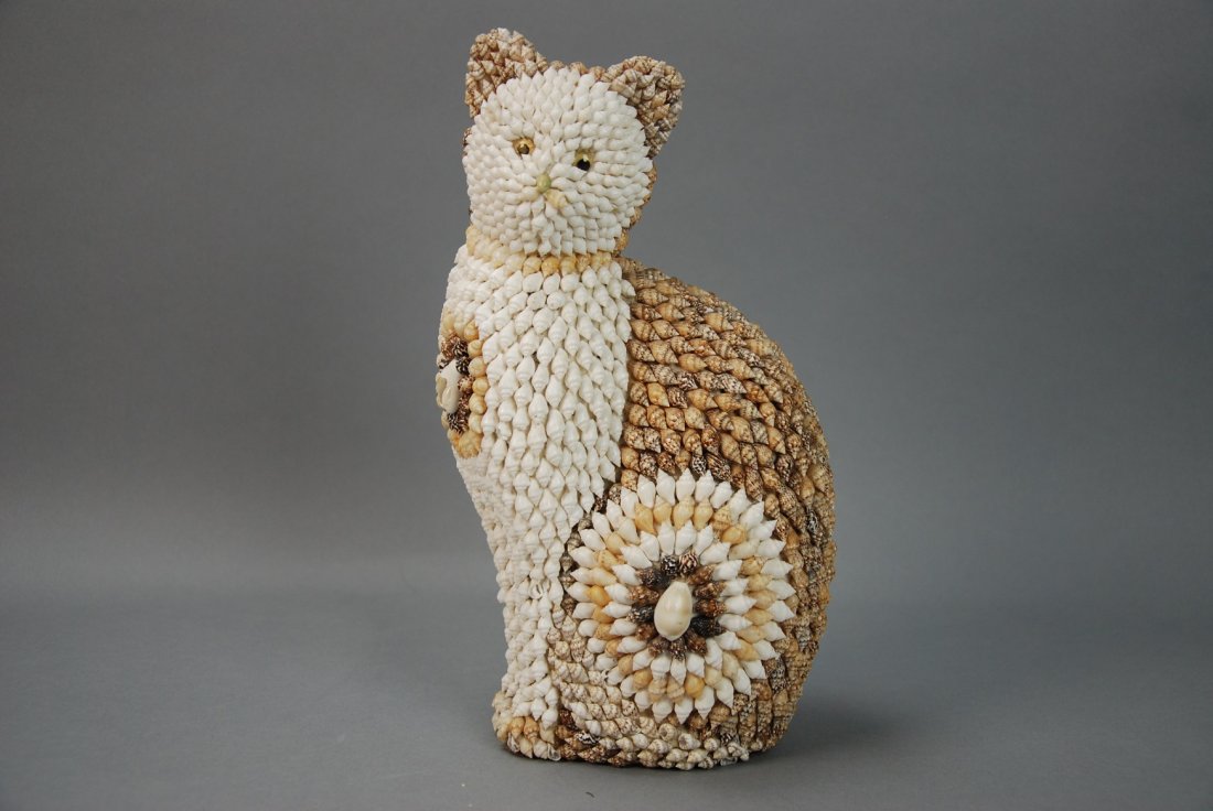 A seashell covered cat: This piece is very detailed, it is covered in thousand of seashells. The resulting piece is very lifelike and intricate. Height 9.5 in