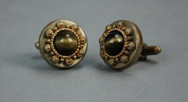 An antique pair of cats eye cufflinks: These vintage cufflinks feature two brown cats eye stones