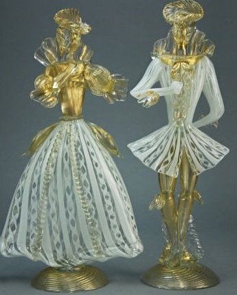 A pair of 19th century Murano figures: These pieces are blown glass, depicting a male and female dancer. Each dancer has gilt inclusions and lattice work costumes, rising on circular plinths. Provenance: Property from a private collection,