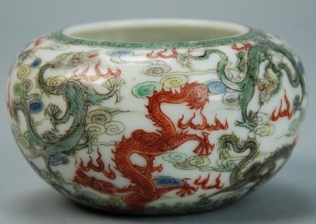 A Qing Dynasty enamel nine dragon brush washer: This piece is very magnificent. There are nine dragons in total, each one is a different color. In the background are clouds and flames. Diameter 3 in, Height 2 in