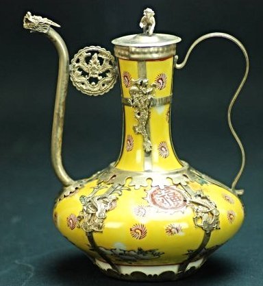 A famille rose silver teapot: This piece is very beautiful, there are six dragons on the side of this vase. The snout of this teapot is a dragon. There is the Chinese character Fu for luck on this piece. Height 6.6 in