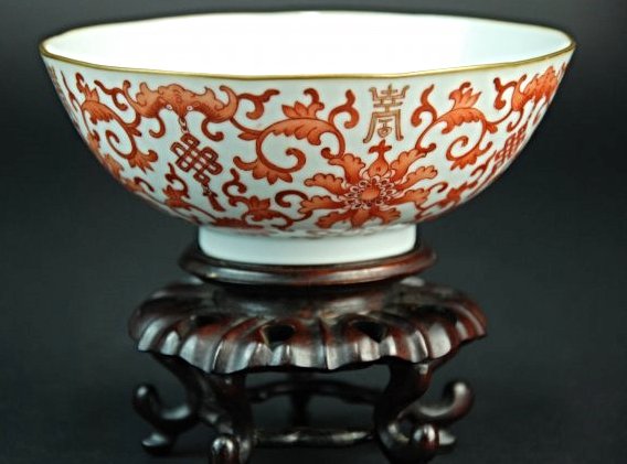 A Xianfeng period iron red bowl: This piece features an iron red glaze. There are designs of flowers, vines, bats and symbols on the surface of the bowl. There is a Xianfeng marker. Provenance: A British private collection. Bowl heig
