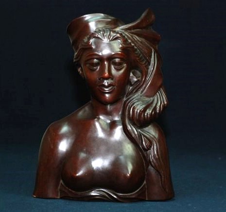 A Bali Wood carving of a woman: This piece is signed by A.A. Fatimah, Bali. A.A. Fatimah was renowned for his ebony sculptures, but also made use of other local hardwoods, such as sandalwood. His peak of production was in the 1940's