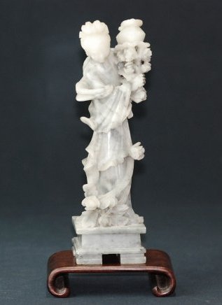 A fine carved soapstone figure: A soapstone ladies waved a basket of flowers.Height 25cm.