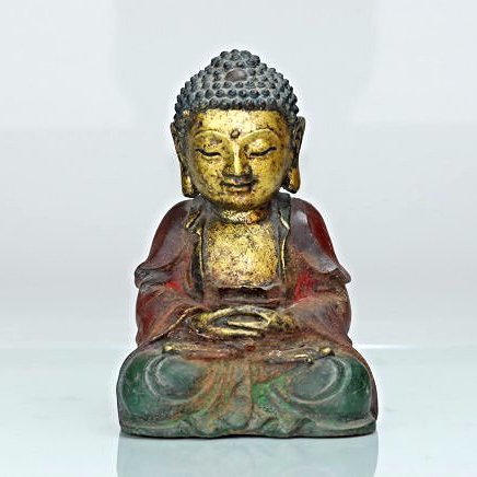 A Ming dynasty cast bronze figure of a Buddha: This piece is a gilt bronze and painted piece. This Buddha is seen in a meditation stance. Height 9 in, Width 6 in