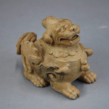 A Han Dynasty jade mythical beast: This piece depicts a mythical beast. It was unearthed from a tomb. Height 9 cm, Length 9.5cm