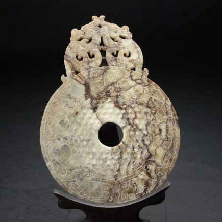 An antique jade circular plaque carving (1 of 2)